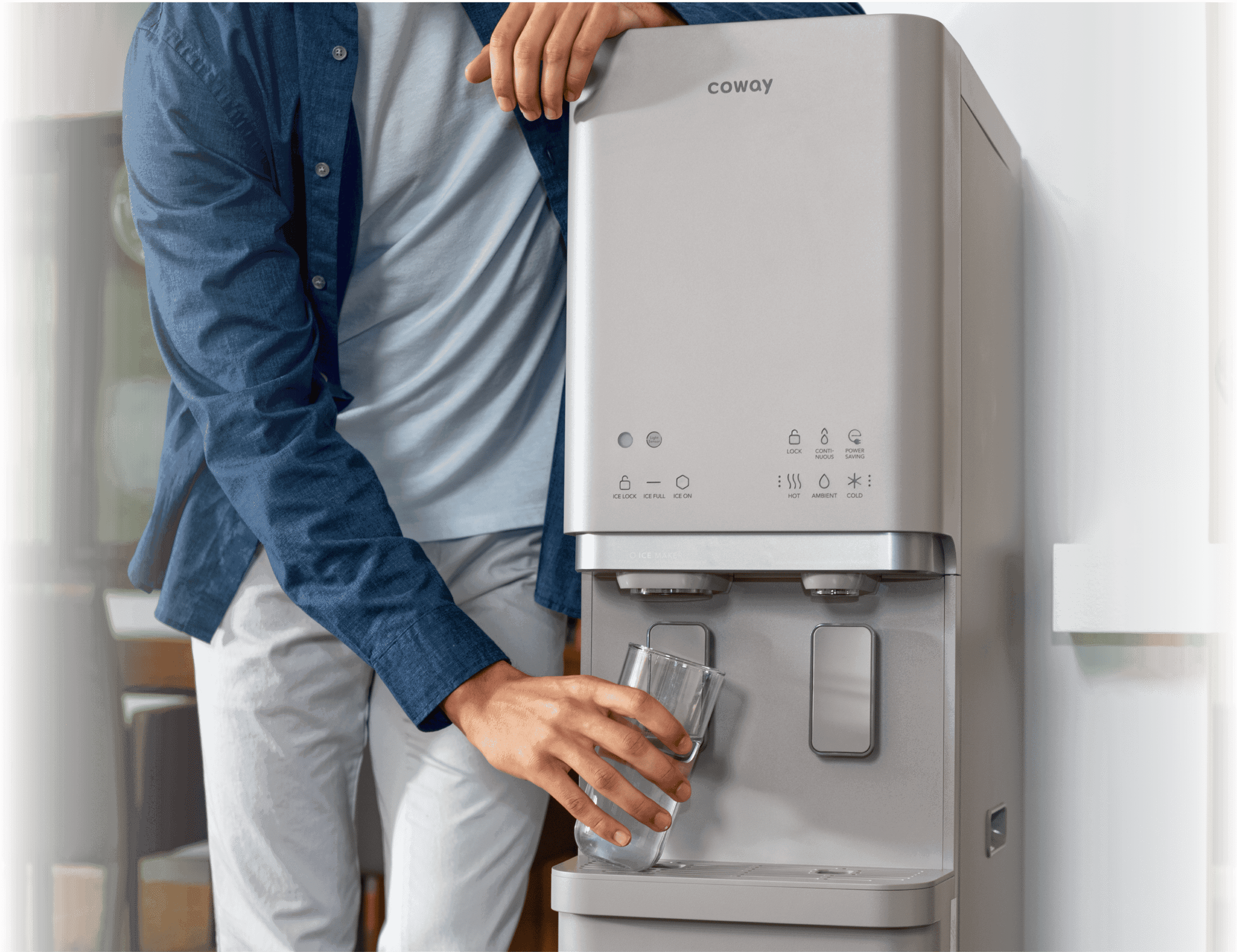 Man getting water from Coway CHPI-620L Plus water purifier